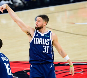 NBA: Klay Thompson holds his follow-through after making a three-pointer for the Dallas Mavericks against the Chicago Bulls