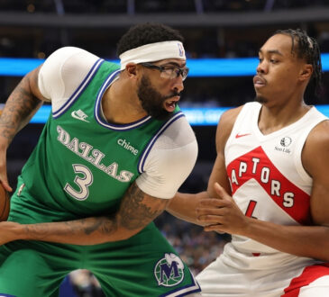 Anthony Davis of the Dallas Mavericks is defended by Scottie Barnes of the Toronto Raptors during the first half at American Airlines Center