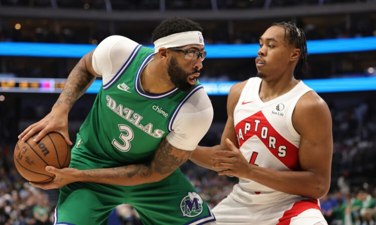 Anthony Davis of the Dallas Mavericks is defended by Scottie Barnes of the Toronto Raptors during the first half at American Airlines Center