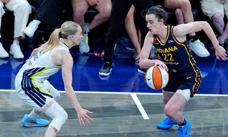 WNBA: Indiana Fever guard Caitlin Clark brings the ball up court against Dallas Wings guard Paige Bueckers at Gainbridge Fieldhouse on July 13, 2025