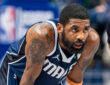 Kyrie Irving leans forward on the court while free throws are attempted during the Dallas Mavericks’ game against the Golden State Warriors at American Airlines Center NBA