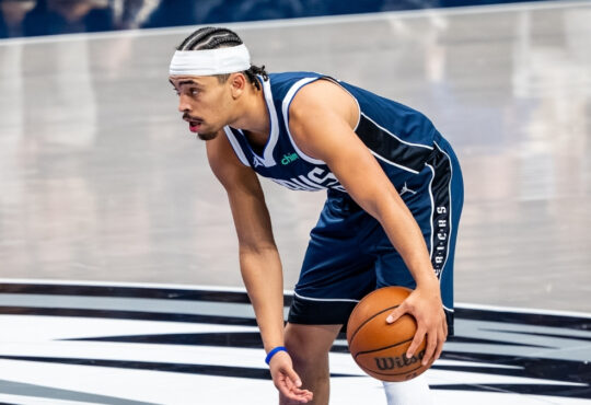 Ryan Nembhard dribbles the ball near midcourt at American Airlines Center before Mavericks vs. Nets