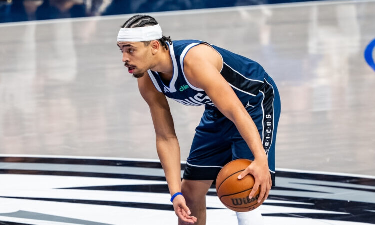 Ryan Nembhard dribbles the ball near midcourt at American Airlines Center before Mavericks vs. Nets