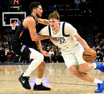 NBA: Cooper Flagg dribbles past Devin Booker during the first half of Mavericks vs. Suns at Mortgage Matchup Center in Phoenix.