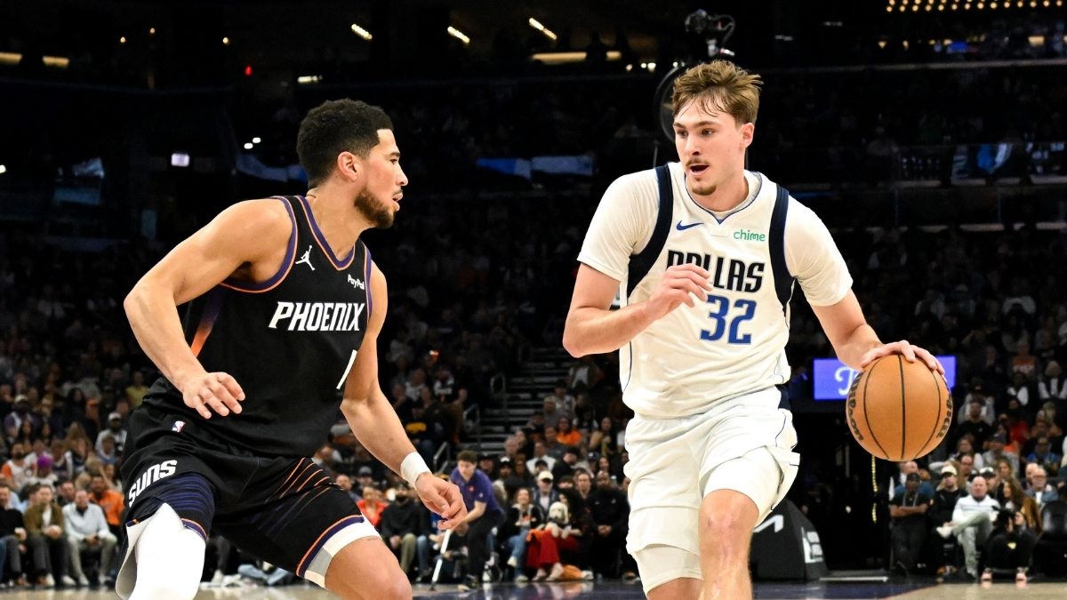 NBA: Cooper Flagg dribbles the ball for the Dallas Mavericks while defended by Devin Booker of the Phoenix Suns at Mortgage Matchup Center.