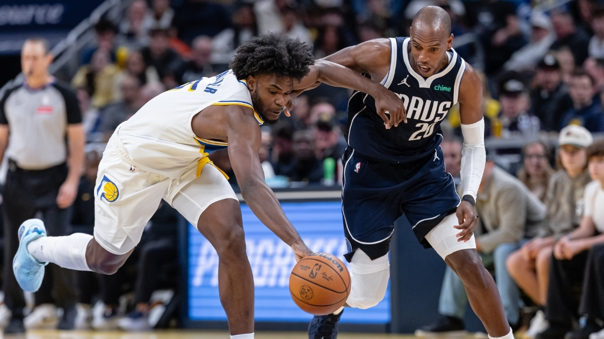 NBA: Khris Middleton of the Dallas Mavericks and Jarace Walker of the Indiana Pacers chase a loose ball during the first half at Gainbridge Fieldhouse against the Indiana Pacers.