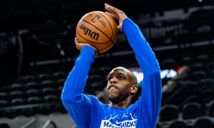 NBA: Khris Middleton takes a jump shot during pregame warmups for the Dallas Mavericks in San Antonio