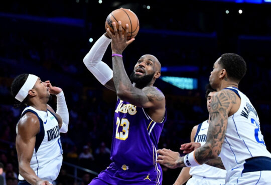 NBA: LeBron James drives to the basket at Crypto.com Arena between Brandon Williams and P.J. Washington during Dallas Mavericks vs. Los Angeles Lakers.