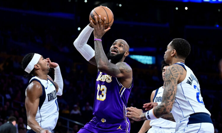 NBA: LeBron James drives to the basket at Crypto.com Arena between Brandon Williams and P.J. Washington during Dallas Mavericks vs. Los Angeles Lakers.