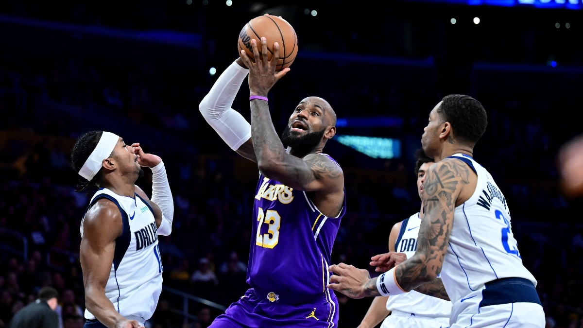 NBA: LeBron James drives to the basket at Crypto.com Arena between Brandon Williams and P.J. Washington during Dallas Mavericks vs. Los Angeles Lakers.