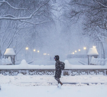 A commuter walks through heavy snowfall in Central Park during a Nor’Easter in New York City.