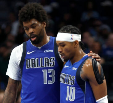 NBA: Naji Marshall and Brandon Williams walk to the bench during the second half of the Dallas Mavericks game against the Sacramento Kings at American Airlines Center.