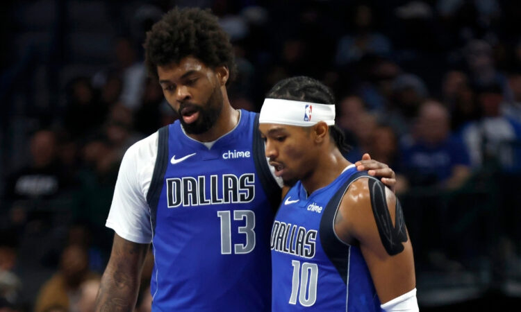 NBA: Naji Marshall and Brandon Williams walk to the bench during the second half of the Dallas Mavericks game against the Sacramento Kings at American Airlines Center.