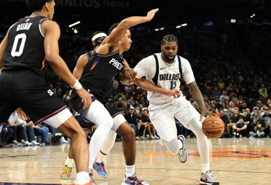 NBA: Naji Marshall brings the ball up court for the Dallas Mavericks while defended by Oso Ighodaro of the Phoenix Suns at Mortgage Matchup Center.