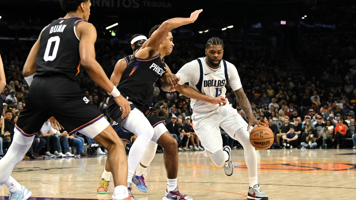 NBA: Naji Marshall brings the ball up court for the Dallas Mavericks while defended by Oso Ighodaro of the Phoenix Suns at Mortgage Matchup Center.