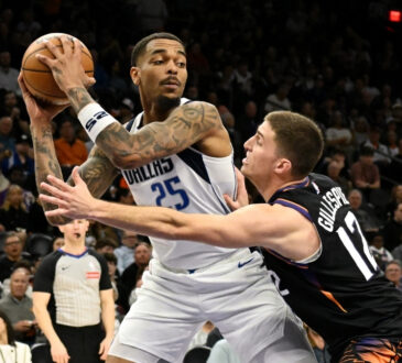 NBA: P.J. Washington looks to pass the ball for the Dallas Mavericks while defended by Collin Gillespie at Mortgage Matchup Center against the Phoenix Suns.