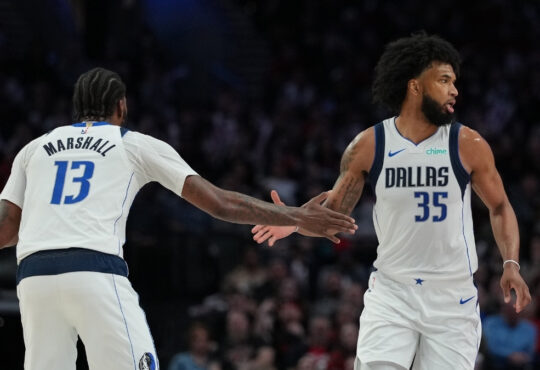 Marvin Bagley III (#35) and Naji Marshall (#13) of the Dallas Mavericks celebrate during a road game against the Portland Trail Blazers at Moda Center on March 27, 2026.