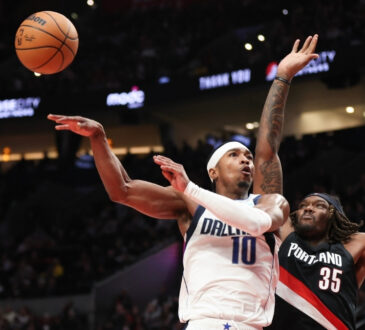Brandon Williams of the Dallas Mavericks passes away from Robert Williams III of the Portland Trail Blazers during the fourth quarter at Moda Center on December 29, 2025.