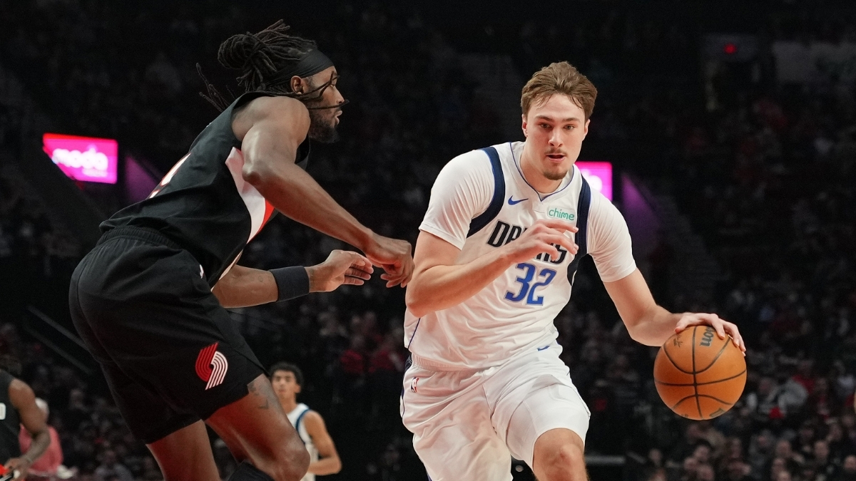 Cooper Flagg #32 of the Dallas Mavericks dribbles against Jerami Grant #9 of the Portland Trail Blazers during a 20-point first half at Moda Center.