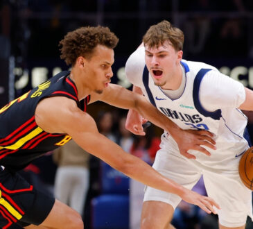 Cooper Flagg #32 of the Dallas Mavericks battles Dyson Daniels #5 of the Atlanta Hawks during the first quarter at State Farm Arena.