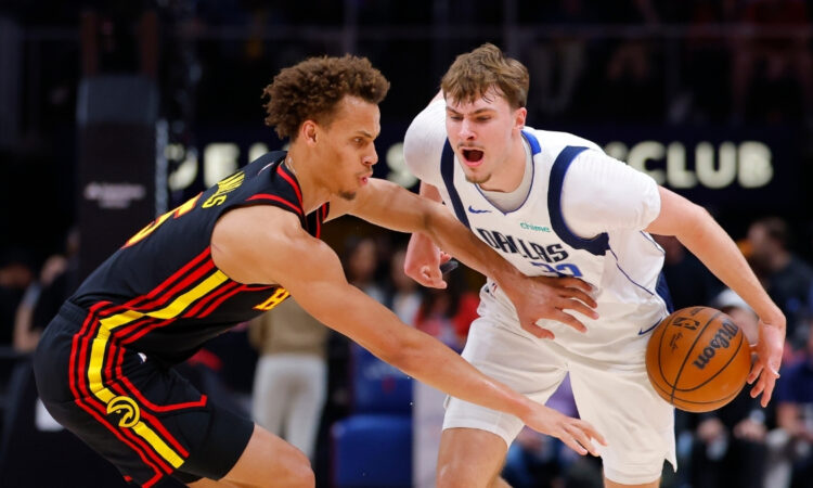 Cooper Flagg #32 of the Dallas Mavericks battles Dyson Daniels #5 of the Atlanta Hawks during the first quarter at State Farm Arena.