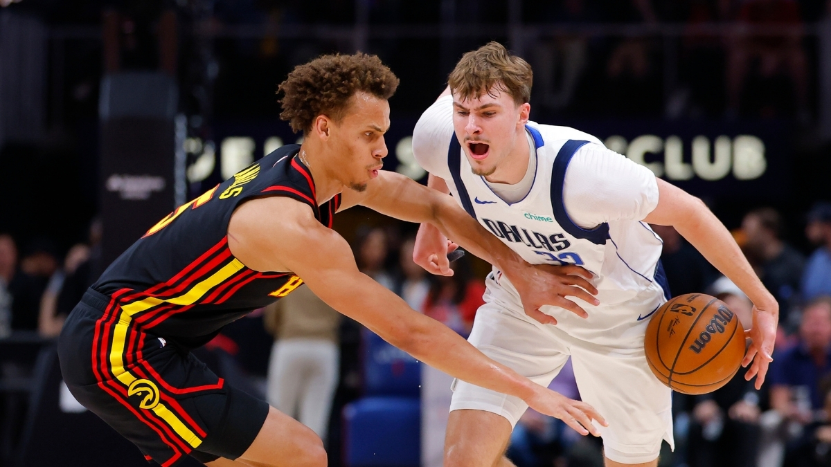 Cooper Flagg #32 of the Dallas Mavericks battles Dyson Daniels #5 of the Atlanta Hawks during the first quarter at State Farm Arena.