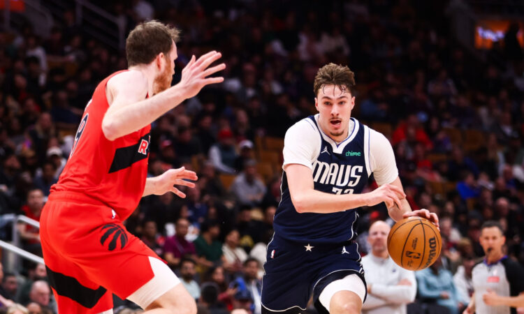 Cooper Flagg #32 of the Dallas Mavericks drives to the basket against Jakob Poeltl #19 of the Toronto Raptors at Scotiabank Arena on March 8, 2026.