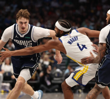 Dallas Mavericks rookie Cooper Flagg drives against Moses Moody of the Golden State Warriors during the third quarter at American Airlines Center on March 23, 2026.
