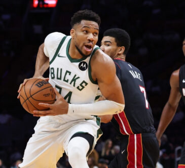 Giannis Antetokounmpo of the Milwaukee Bucks drives to the basket against the Miami Heat defense at Kaseya Center.