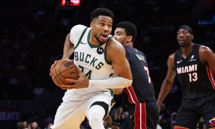Giannis Antetokounmpo of the Milwaukee Bucks drives to the basket against the Miami Heat defense at Kaseya Center.