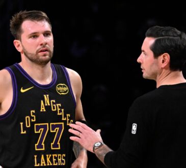 Los Angeles Lakers head coach JJ Redick talks with Luka Dončić during a game against the Utah Jazz at Crypto.com Arena on November 18, 2025.