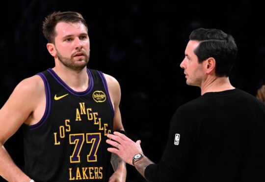 Los Angeles Lakers head coach JJ Redick talks with Luka Dončić during a game against the Utah Jazz at Crypto.com Arena on November 18, 2025.