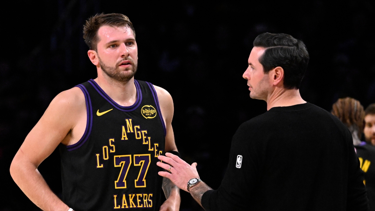 Los Angeles Lakers head coach JJ Redick talks with Luka Dončić during a game against the Utah Jazz at Crypto.com Arena on November 18, 2025.