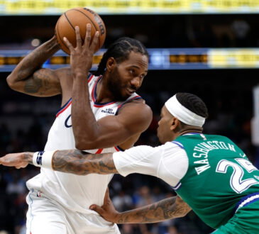Kawhi Leonard looks toward the basket as P.J. Washington defends during overtime of the Clippers’ game against the Mavericks on March 21, 2026 at American Airlines Center.