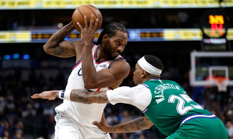 Kawhi Leonard looks toward the basket as P.J. Washington defends during overtime of the Clippers’ game against the Mavericks on March 21, 2026 at American Airlines Center.