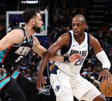 Khris Middleton of the Dallas Mavericks handles the ball against Tyler Burton of the Memphis Grizzlies during the first half at FedExForum on March 12, 2026.