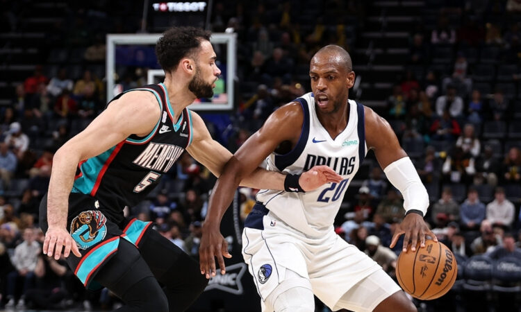 Khris Middleton of the Dallas Mavericks handles the ball against Tyler Burton of the Memphis Grizzlies during the first half at FedExForum on March 12, 2026.