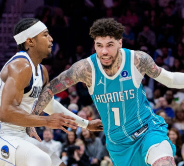 NBA: LaMelo Ball brings the ball up court for the Charlotte Hornets while guarded by Brandon Williams of the Dallas Mavericks during a game at Spectrum Center.