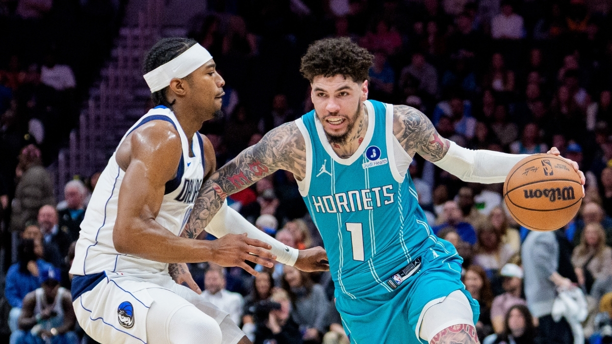 NBA: LaMelo Ball brings the ball up court for the Charlotte Hornets while guarded by Brandon Williams of the Dallas Mavericks during a game at Spectrum Center.