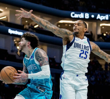 NBA: LaMelo Ball drives to the basket for the Charlotte Hornets while guarded by P.J. Washington of the Dallas Mavericks at Spectrum Center.