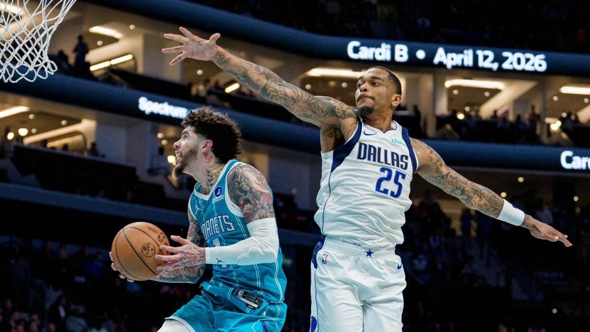 NBA: LaMelo Ball drives to the basket for the Charlotte Hornets while guarded by P.J. Washington of the Dallas Mavericks at Spectrum Center.