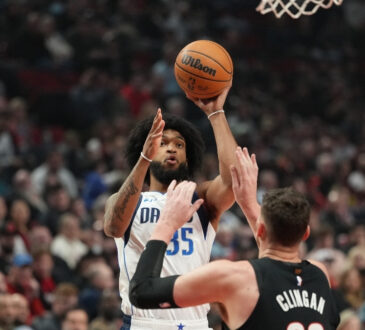 Marvin Bagley III #35 of the Dallas Mavericks shoots a jumper over Donovan Clingan #23 of the Portland Trail Blazers at Moda Center.