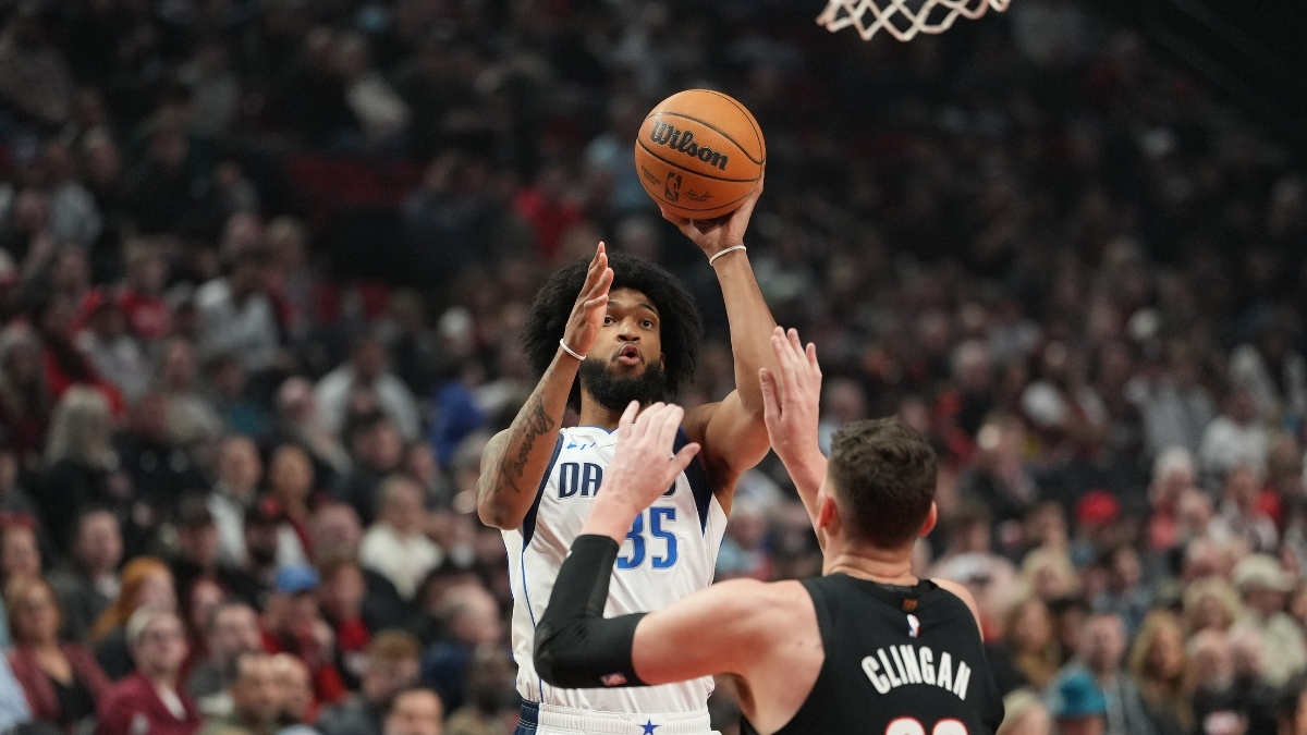 Marvin Bagley III #35 of the Dallas Mavericks shoots a jumper over Donovan Clingan #23 of the Portland Trail Blazers at Moda Center.