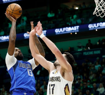 Naji Marshall #13 of the Dallas Mavericks shoots over Karlo Matković #17 of the New Orleans Pelicans during the first half at Smoothie King Center on March 16, 2026.