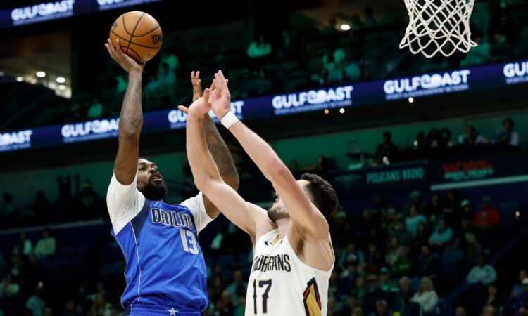 Naji Marshall #13 of the Dallas Mavericks shoots over Karlo Matković #17 of the New Orleans Pelicans during the first half at Smoothie King Center on March 16, 2026.