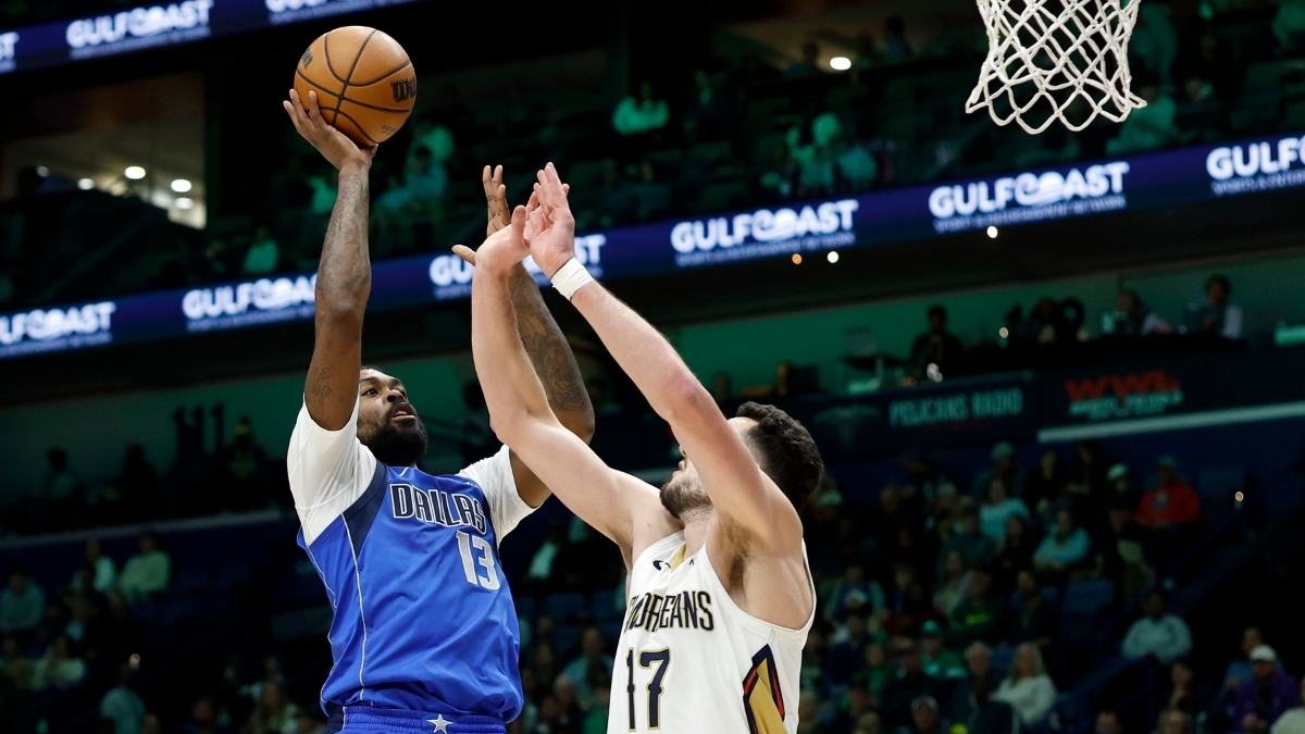 Naji Marshall #13 of the Dallas Mavericks shoots over Karlo Matković #17 of the New Orleans Pelicans during the first half at Smoothie King Center on March 16, 2026.