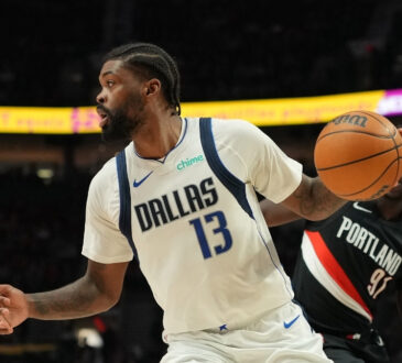 Naji Marshall #13 of the Dallas Mavericks drives with the ball against the Portland Trail Blazers at Moda Center.
