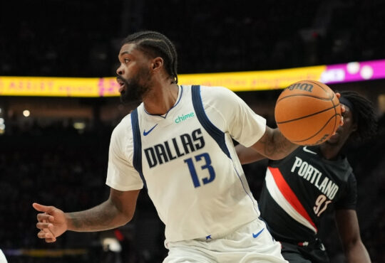 Naji Marshall #13 of the Dallas Mavericks drives with the ball against the Portland Trail Blazers at Moda Center.