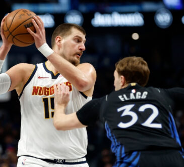 Denver Nuggets star Nikola Jokić dribbles as Dallas Mavericks rookie Cooper Flagg defends during the first half on December 23, 2025 in Dallas.