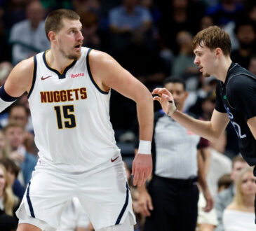 Nikola Jokic of the Denver Nuggets controls the ball while defended by Dallas Mavericks rookie Cooper Flagg during the second half on December 23, 2025 in Dallas.